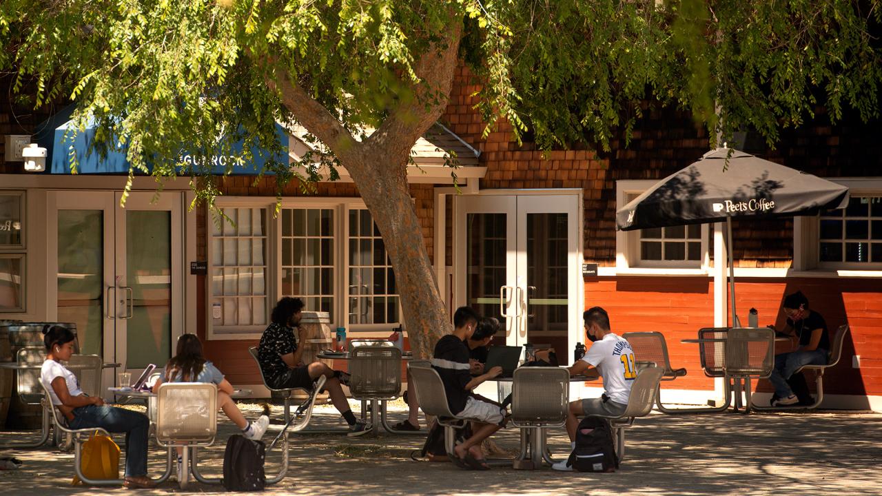Students sit at lunch tables outside the Silo.