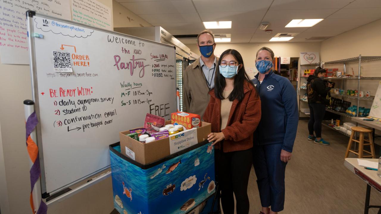 3 people pose during tour of the ASUCD Pantry