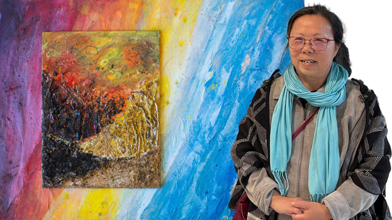 Artist is pictured in front of one of her paintings