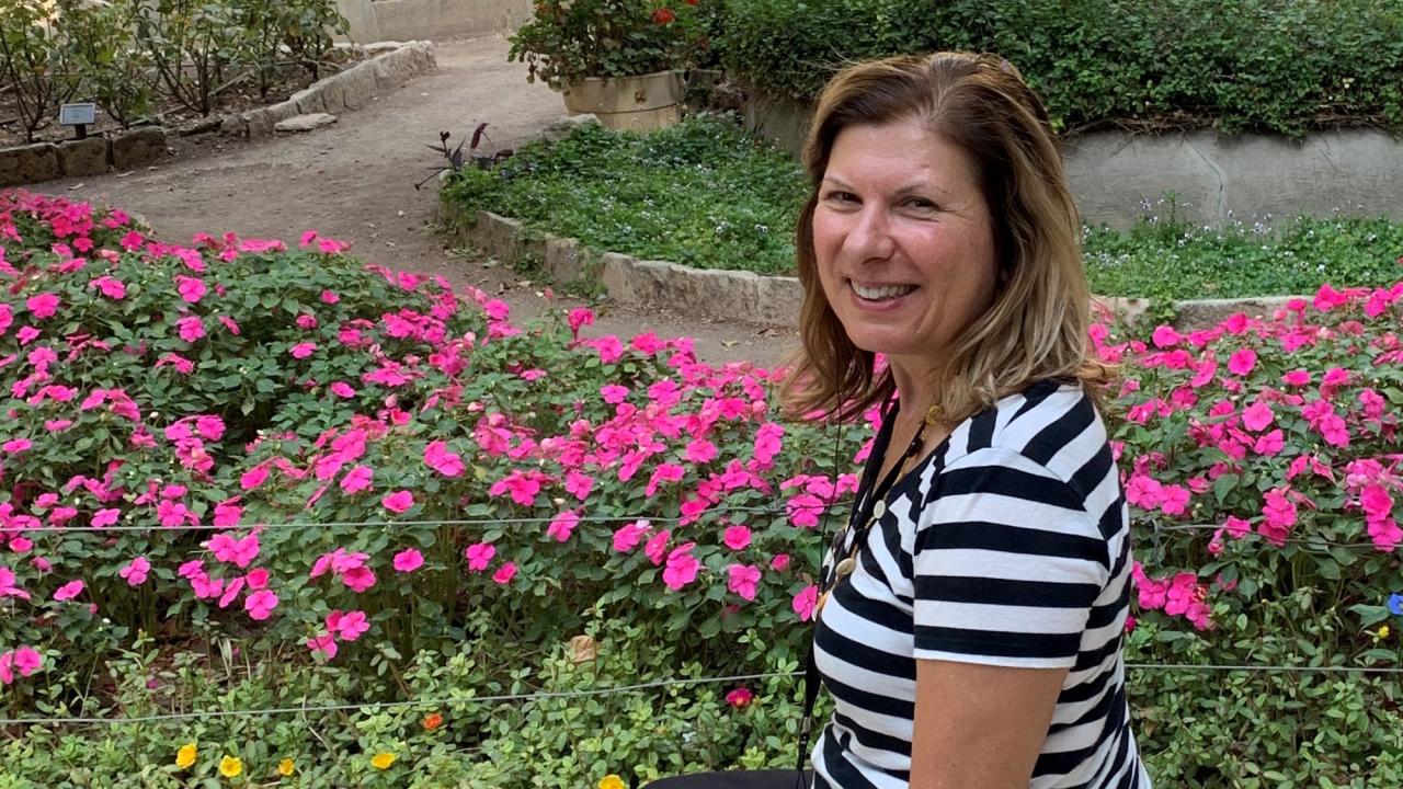 Rita Gibson environmental, seated, flowers in background