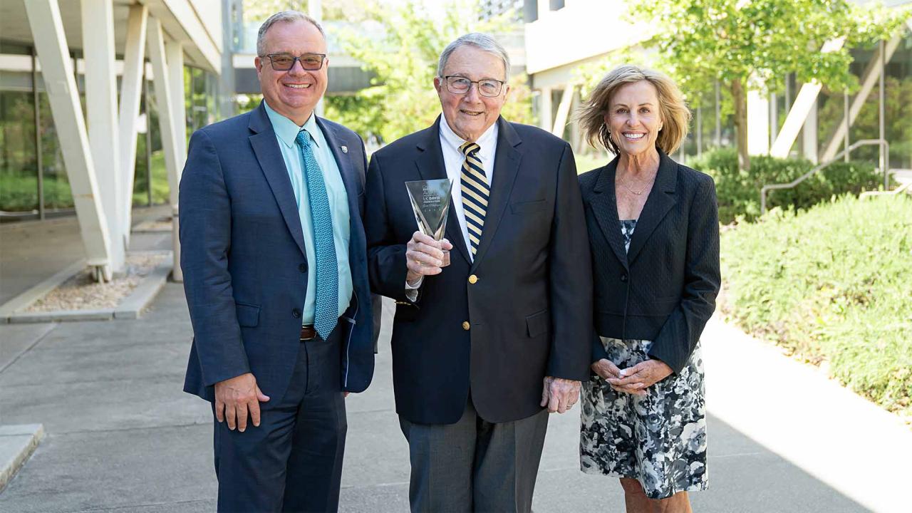 Three people pose for photo