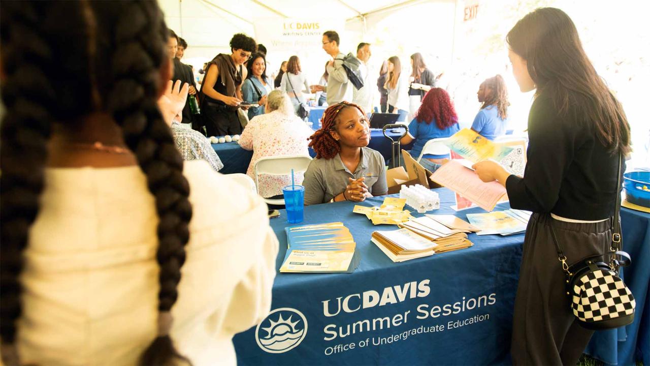 Student gets information at Summer Sessions informational table