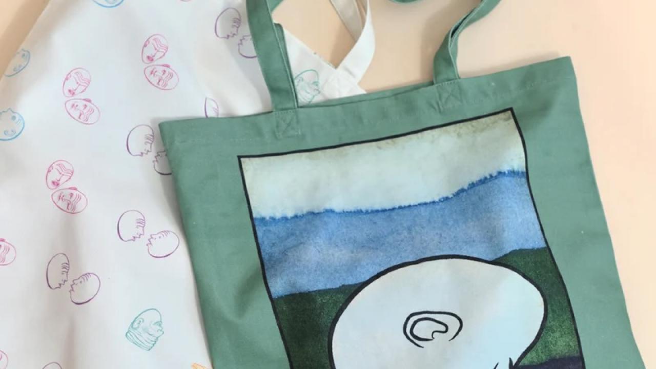 Two designs of tote bags for the Arneson Egghead Collection include pastel (with all Eggheads) and the popular "El Bookhead" design in the style of Mexican loteria cards