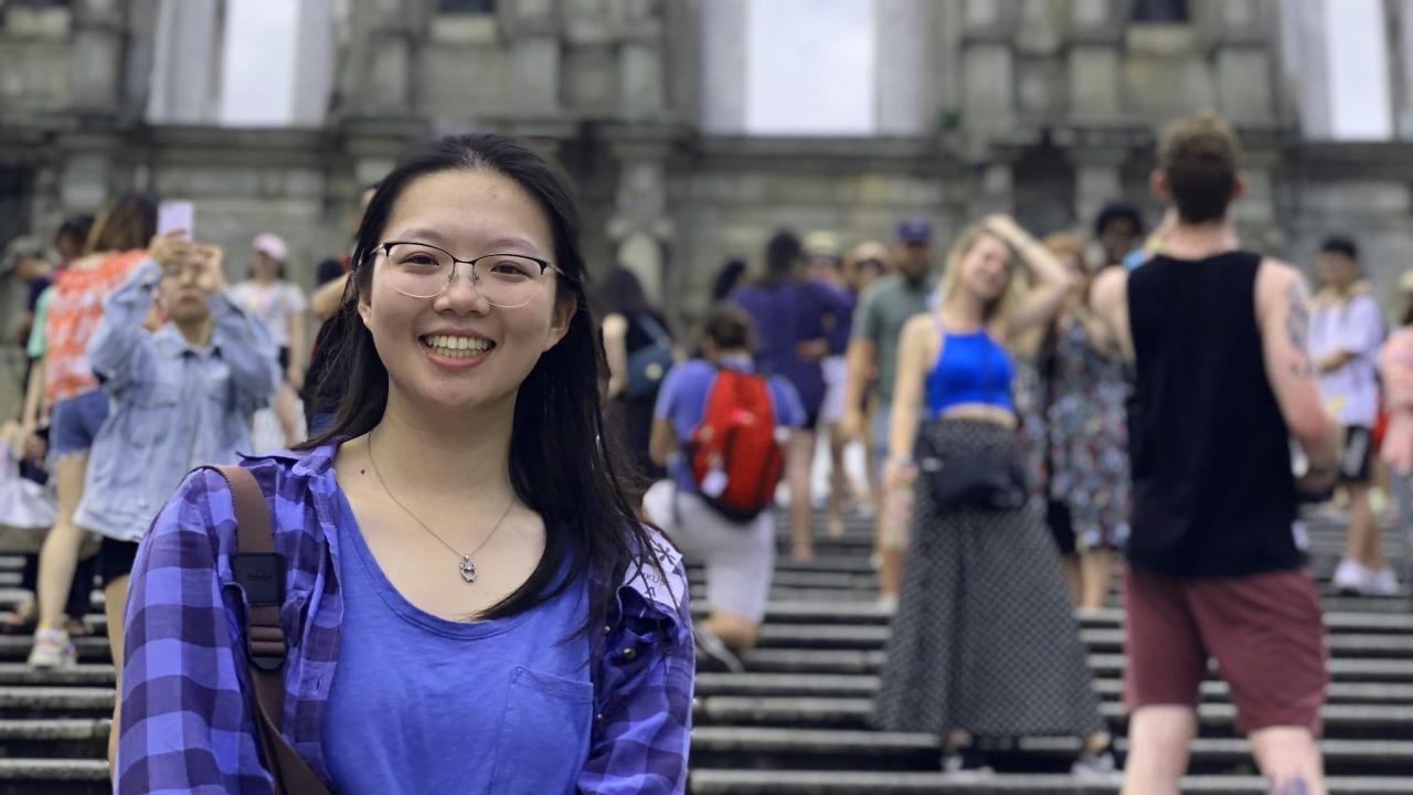 Fionna Huang stands on a crowded street in Hong Kong. 