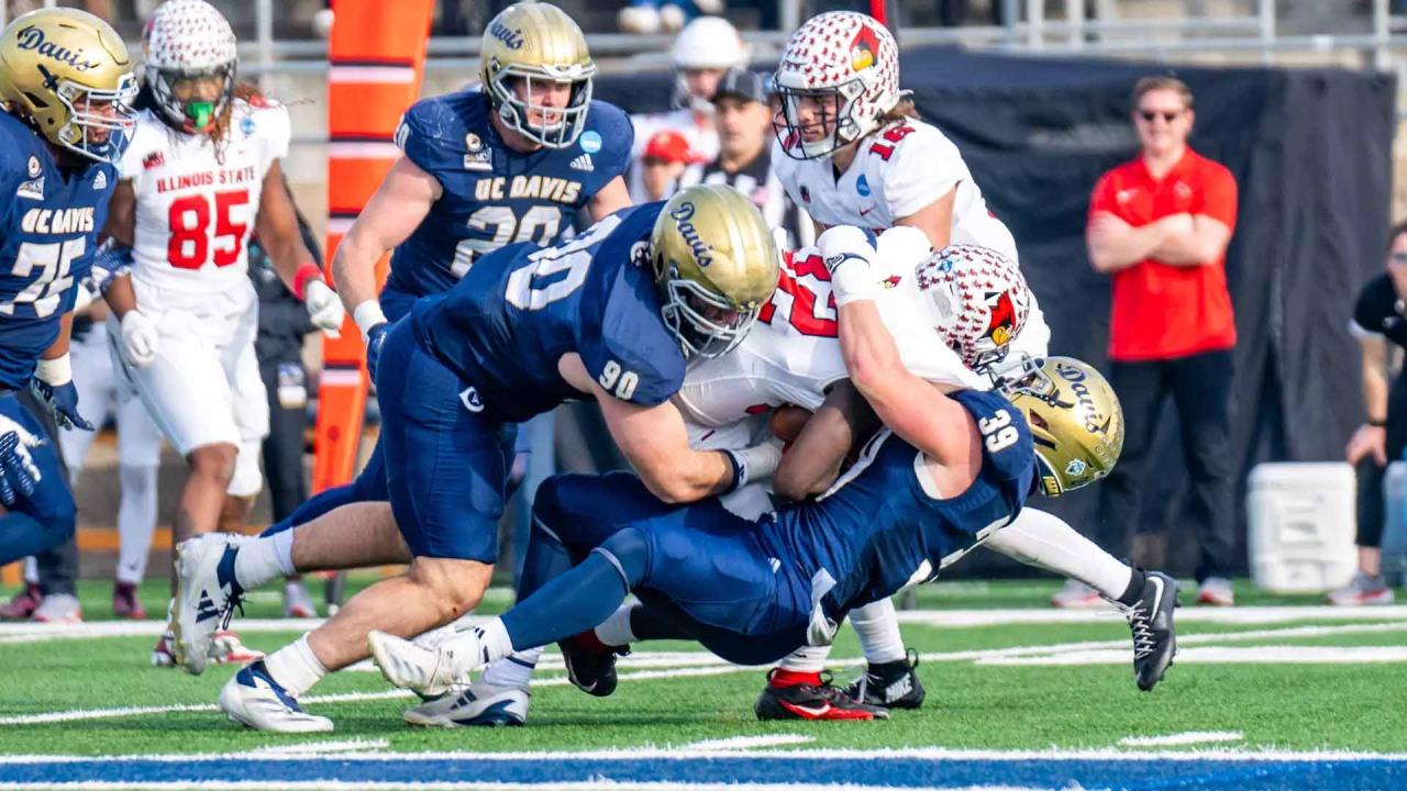Football player tackles opponent
