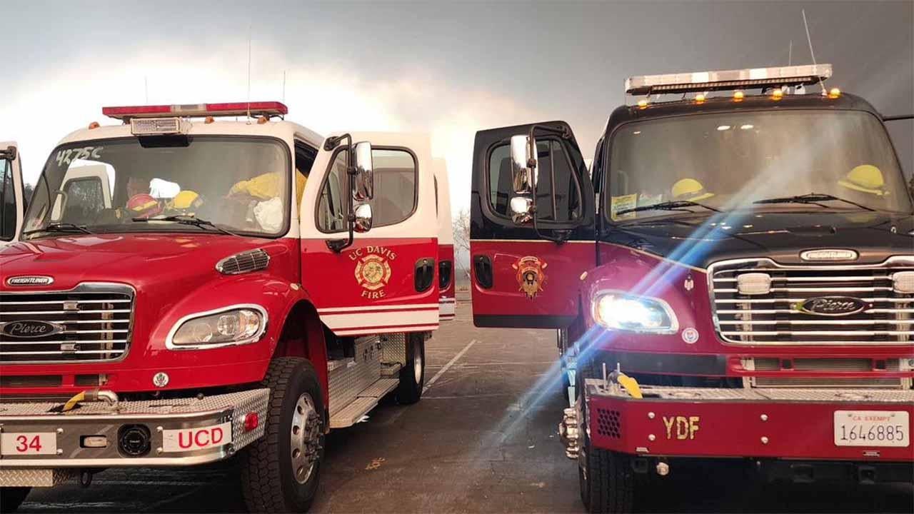 Two fire trucks are parked next to each other.