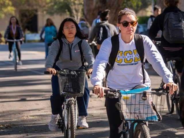 Woman biking on UC Davis campus