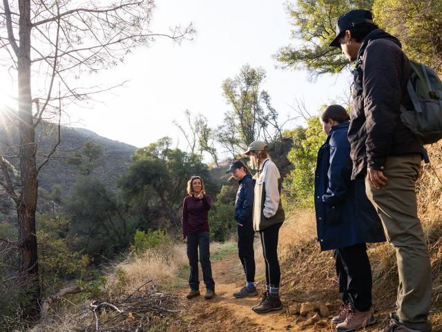 A teacher and students on a hiking trail