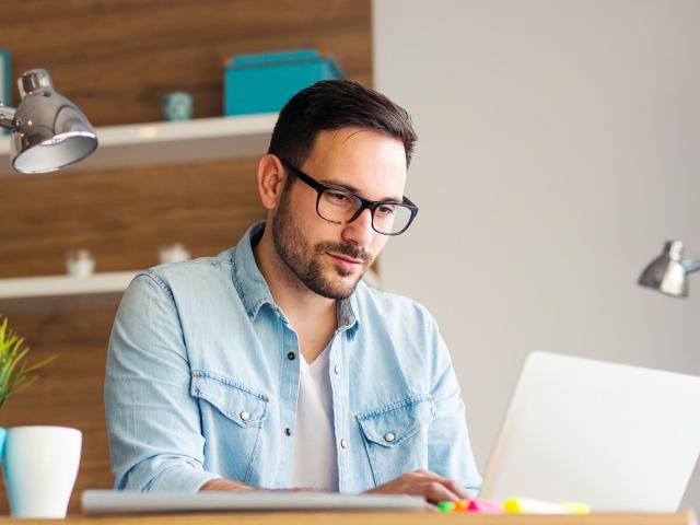 a person on their laptop looking at research news