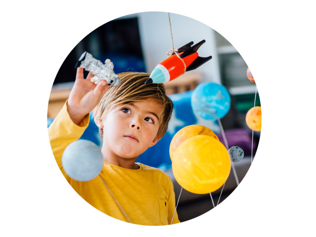 A child playing with a solar system model