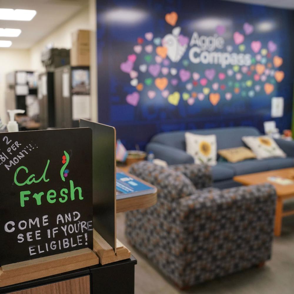 An interior shot of the Aggie Compass Basic Needs Center featuring a wall covered in heart shaped notes left by 