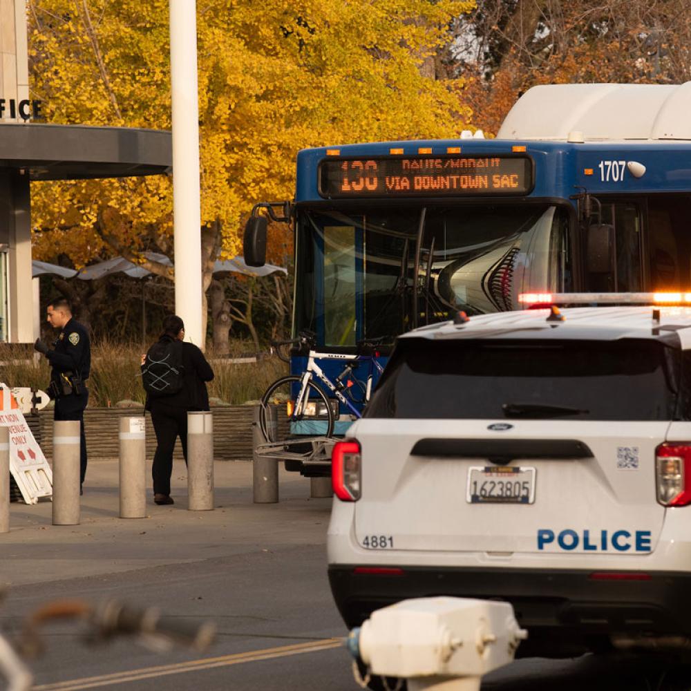 A policeman questioning a student outside of his patrol car