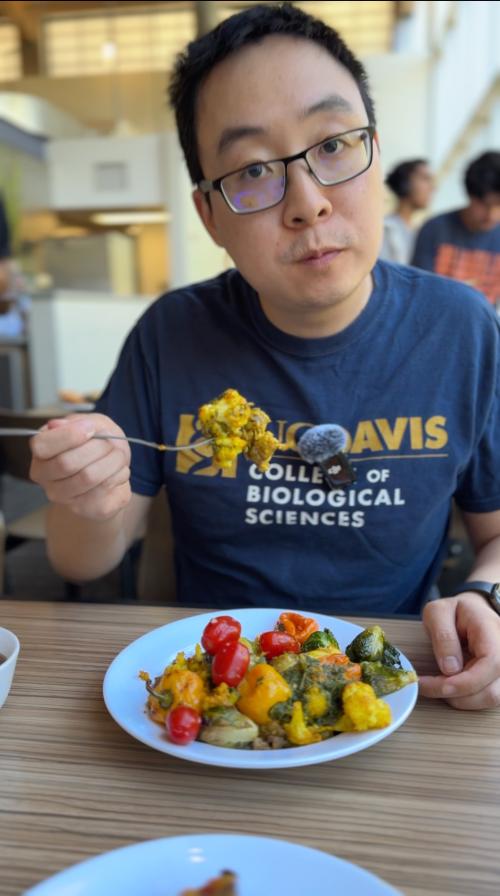 Man with plate of food sits at table