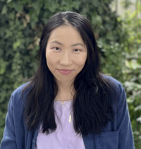 Woman with long dark hair photographed in garden setting 