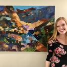 Fourth-year art studio major McKinna Salinas stands in front of her work, "Mountain Yellow-legged Frog." 