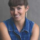 Portrait of a woman in a sleeveless jean shirt