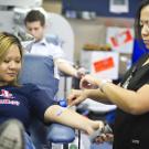 Photo: In the bloodmobile, Abby Lee, head charge nurse, prepares to draw blood from Jennifer Truong, a senior animal science major, on Aug. 28, 2012.