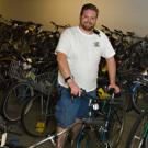Scott Hutchison, Bicycle Program assistant, shows off some of the more than 350 bicycles that are due to go up for auction May 3.