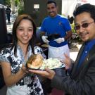 Staff Assembly&rsquo;s Alyssa Varela and Peter Blando display a meal much like those to be served at the 2008 TGFS Picnic on May 7: A Buckhorn Steak & Roadhouse tri-tip sandwich and Granny Smith apple coleslaw. The Buckhorn&rsquo;s Silverio Arteaga did 