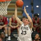photo: man tossing ball at hoop