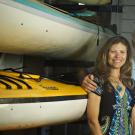 Photo: Sharon Coulson and Ted Abresch, husband and wife, in front of ocean kayaks at Outdoor Adventures