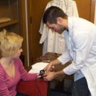 UC Davis Psychologist Jonathan Helm and a student set up machinery to study heart rates and respiration in romantic couples