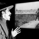 A narrator from the Japanese "benshi" tradition takes the stage in front of a screen on which a classic Mexican silent film is playing.