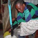 In the Kibera slum outside Nairobi, Kenya, an unidentified community health worker demonstrates the flash-heating process -- using a glass jar of cow'