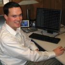 Greg Loge aims to ensure UC Davis computer networks are equipped with safeguards like firewalls, such as the one running on the monitor behind him.