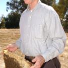 Eric Mussen and a frame from a beehive.