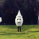photo: three people inside giant human heads