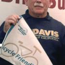 Photo: David Takemoto-Weerts displays the campus's new bicycle-friendly university pennant, after receiving it in Washington, D.C.