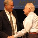 Alan Meier, a visiting scientist at the UC Davis Energy Efficiency Center, congratulates Arthur Rosenfeld during the March 9 symposium.