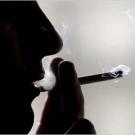 Unidentified person inhales on a cigarette.