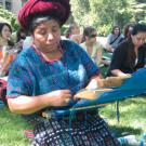 Bertina Lopez de Martin demonstrates the making of weft brocade fabric, which is used in the huipil, a traditional blouse for Mayan women.