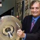 Photo: Man opening a door to lab machine