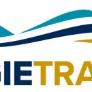 Lblue-and-gold "swoosh"-style lines, depicting airplaneogo: AggieTravel under 