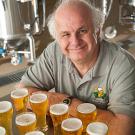 Charlie Bamforth with a number of glasses of beer on a table