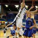 Photo: women playing basketball, with one going for a layup