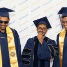 Photo: Three soon-to-be-graduates in UC Davis' new commencement gowns: blue with gold trim