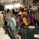 Chancellor and others writing on poster pads on easels.