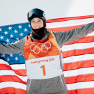 Brita Sigourney holds U.S. flag behind her back.