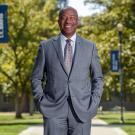 Chancellor Gary S. May stands on Centennial Walk. 