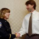 Capt. Leslie Brown thanks Peter Anderson for helping out after a shooting on campus in December.