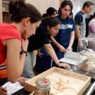 Photo: Row of students working at tables filled with skeletons