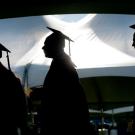 Photo: Three graduates in silhouette