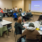 Students in groups at tables
