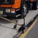 photo: truck with equipment sealing crack in road