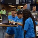 Students with robot and laptop