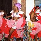 Photo: Three women in costume dancing, holding skirts up